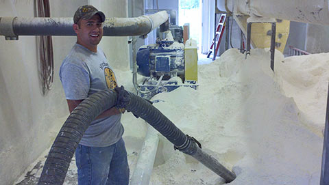Mitchel Enterprises Ops Manager operates vacuum truck to clean up flour spill.